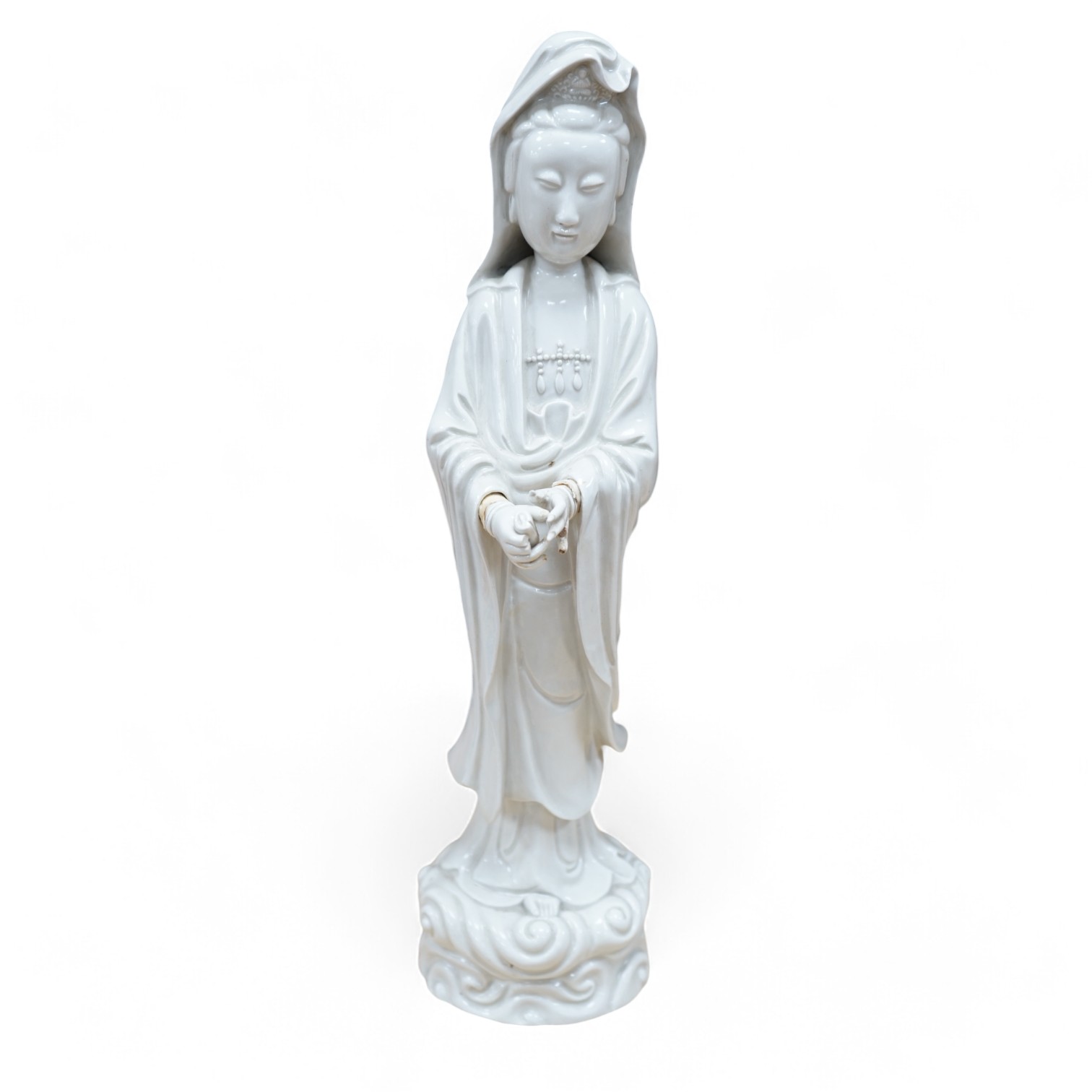 A Chinese blanc de chine figure of Guanyin, 45cm high. Condition - poor to fair, a number of fingers broken and missing